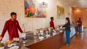 Guests enjoying authentic Rajasthani cuisine at a luxury camp in Jaisalmer with elegant desert tents and warm hospitality.
