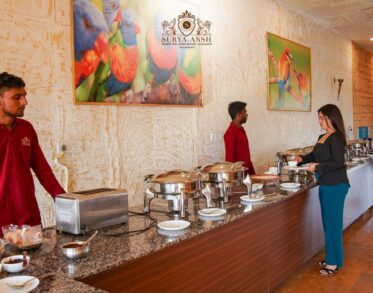 Guests enjoying authentic Rajasthani cuisine at a luxury camp in Jaisalmer with elegant desert tents and warm hospitality.
