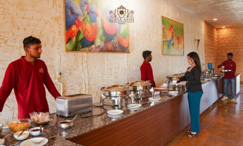 Guests enjoying authentic Rajasthani cuisine at a luxury camp in Jaisalmer with elegant desert tents and warm hospitality.