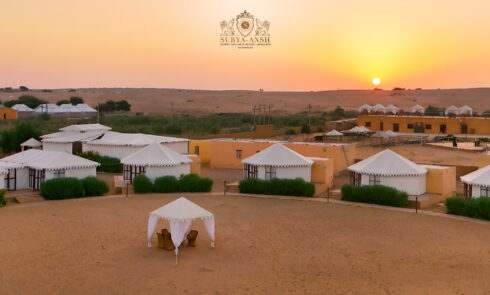 Aerial view of Suryaansh luxury camp in Jaisalmer surrounded by the golden Thar Desert.