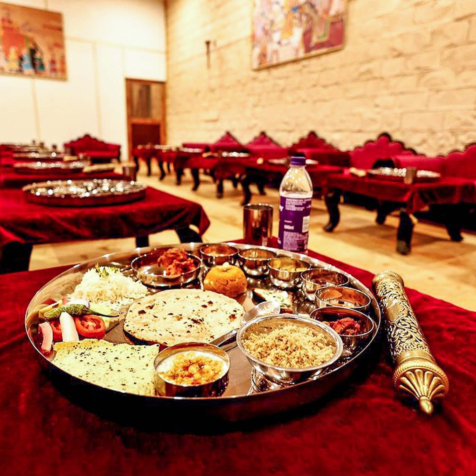 Guests enjoying a royal outdoor dining experience at a luxury camp in Jaisalmer.